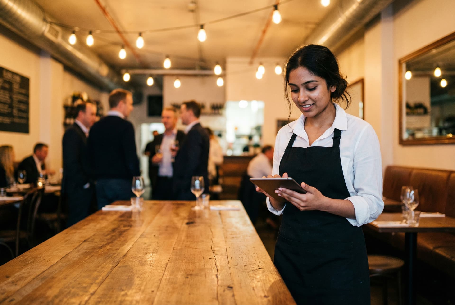 Waitress taking orders in a busy restaurant
